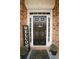 Charming front door with sidelights, wreath, and 'welcome' sign at 118 Jasmine Way, Carrollton, GA 30180