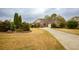Well-maintained property featuring verdant lawn, a driveway, and established landscaping at 118 Jasmine Way, Carrollton, GA 30180