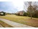 Residential home featuring a lush front lawn, a well-maintained exterior, and mature trees at 118 Jasmine Way, Carrollton, GA 30180