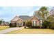 Charming brick home boasts well-manicured landscaping, a driveway, and a classic, inviting facade at 118 Jasmine Way, Carrollton, GA 30180