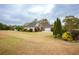 Residential home showcasing a large, grassy yard, trimmed shrubs, and mature shade trees at 118 Jasmine Way, Carrollton, GA 30180
