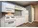 Modern kitchen featuring white cabinets, countertops, and appliances at 118 Jasmine Way, Carrollton, GA 30180