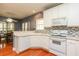 Well-lit kitchen features modern appliances and an adjacent dining area at 118 Jasmine Way, Carrollton, GA 30180