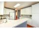 Spacious kitchen with stone countertops, white cabinets, mosaic backsplash, and open access to adjacent spaces at 118 Jasmine Way, Carrollton, GA 30180