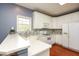 Well-lit kitchen boasts white cabinetry and a stainless steel microwave at 118 Jasmine Way, Carrollton, GA 30180