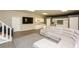 Open living space with a kitchen, island, sectional sofa, and stairs to another level at 118 Jasmine Way, Carrollton, GA 30180