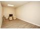Bright living room with wood-look floors, neutral walls, recessed lighting, and comfortable seating at 118 Jasmine Way, Carrollton, GA 30180