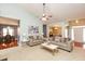 Open concept living room with hardwood floors, a fireplace, and comfortable furniture at 118 Jasmine Way, Carrollton, GA 30180