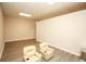 Open-concept living room features light wood floors and two plush chairs at 118 Jasmine Way, Carrollton, GA 30180