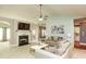 Cozy living room with a fireplace, large TV, and comfortable seating arrangement at 118 Jasmine Way, Carrollton, GA 30180