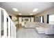 Open concept living room featuring a large sectional sofa and kitchen area at 118 Jasmine Way, Carrollton, GA 30180