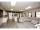 Bright living room featuring a kitchen, island, and comfortable sectional sofa at 118 Jasmine Way, Carrollton, GA 30180