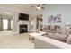 Comfortable living room with fireplace, modern ceiling fan, and neutral-colored walls at 118 Jasmine Way, Carrollton, GA 30180