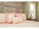 Close up of a large decorative headboard and bed with patterned pink and white pillows at 118 Jasmine Way, Carrollton, GA 30180
