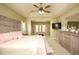 Spacious main bedroom featuring furniture, ceiling fan, and a sitting area with lots of natural light at 118 Jasmine Way, Carrollton, GA 30180