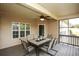 Inviting screened-in patio features a ceiling fan and outdoor dining set at 118 Jasmine Way, Carrollton, GA 30180