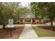 Brick pool house with dark shutters and covered walkway leading to a community pool at 118 Jasmine Way, Carrollton, GA 30180