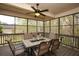 Outdoor screened porch with dining table, seating, and view of the backyard at 118 Jasmine Way, Carrollton, GA 30180