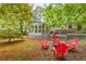 Relaxing backyard with a wooden deck, patio furniture, a fire pit, and mature trees at 2221 Meadow Wood Ct, Marietta, GA 30062
