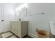 Bright bathroom with a double sink vanity, neutral decor, and updated lighting fixtures at 2221 Meadow Wood Ct, Marietta, GA 30062