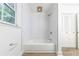 Clean bathroom featuring a white tiled shower, neutral walls, and a hardwood-style floor at 2221 Meadow Wood Ct, Marietta, GA 30062