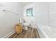 Bright bathroom features white subway tiles, a large window, and a wood-look floor at 2221 Meadow Wood Ct, Marietta, GA 30062