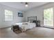 Cozy bedroom with a queen bed, a window offering natural light, and outdoor access to a balcony at 2221 Meadow Wood Ct, Marietta, GA 30062