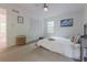 Bright bedroom features neutral decor, a ceiling fan, and a large window for natural light at 2221 Meadow Wood Ct, Marietta, GA 30062