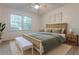 Inviting bedroom features a woven bed frame, natural wood accents, and a sun-filled window view at 2221 Meadow Wood Ct, Marietta, GA 30062