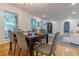 Light and airy dining room featuring hardwood floors, a modern chandelier, and views of a tree-lined yard at 2221 Meadow Wood Ct, Marietta, GA 30062