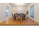 Light and airy dining room featuring hardwood floors, a modern chandelier, and views of a tree-lined yard at 2221 Meadow Wood Ct, Marietta, GA 30062