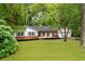 Charming ranch style home with a well-manicured lawn and inviting front porch with wood columns at 2221 Meadow Wood Ct, Marietta, GA 30062