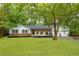 Charming ranch style home with a well-manicured lawn and inviting front porch with wood columns at 2221 Meadow Wood Ct, Marietta, GA 30062