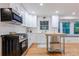 Bright kitchen features white cabinets, modern appliances, a gas range, and hardwood floors at 2221 Meadow Wood Ct, Marietta, GA 30062