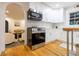 Modern kitchen with stainless steel appliances, white cabinetry, and an open layout to the living room at 2221 Meadow Wood Ct, Marietta, GA 30062