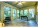 Sunroom with large windows provides plenty of natural light with views of the landscape at 2221 Meadow Wood Ct, Marietta, GA 30062