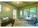 Bright sunroom featuring rustic furniture, a ceiling fan, and great natural light at 2221 Meadow Wood Ct, Marietta, GA 30062