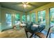 Light-filled sunroom featuring large windows, comfortable seating, and access to an outdoor deck at 2221 Meadow Wood Ct, Marietta, GA 30062