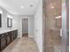 Bathroom featuring a dual sink vanity, tile flooring, and a glass-enclosed shower for spa-like comfort at 2342 Terrace View Sw Cir, Atlanta, GA 30315