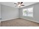 Bedroom features neutral walls and carpet, a ceiling fan, and a window for natural light at 2342 Terrace View Sw Cir, Atlanta, GA 30315