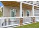 Cozy front porch with a covered ceiling, brick accents, and a charming entry door at 2342 Terrace View Sw Cir, Atlanta, GA 30315