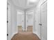 Bright hallway featuring neutral paint, carpet, and doors leading to various rooms in the home at 2342 Terrace View Sw Cir, Atlanta, GA 30315