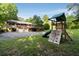 Spacious backyard with lush lawn, mature trees, and a wooden playset for outdoor fun at 1865 Briarlake Cir, Decatur, GA 30033