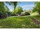 Expansive backyard with grass, trees, a playhouse, play set, and garden for Gathering enjoyment at 1865 Briarlake Cir, Decatur, GA 30033