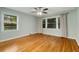 Well-lit bedroom showcasing pristine hardwood floors and lots of natural light at 1865 Briarlake Cir, Decatur, GA 30033