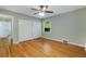 Neutral bedroom featuring gleaming hardwood floors, double closets, and natural light at 1865 Briarlake Cir, Decatur, GA 30033