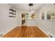 Dining area with stylish lighting, hardwood floors, and an open view to the updated kitchen at 1865 Briarlake Cir, Decatur, GA 30033