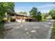 Exterior of home showing drive under garage, porch, backyard deck, and large driveway at 1865 Briarlake Cir, Decatur, GA 30033