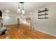 Open-concept living space with hardwood floors, a fireplace, and access to the dining area at 1865 Briarlake Cir, Decatur, GA 30033