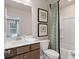Well-appointed bathroom featuring a vanity with storage, framed bee artwork, and a shower with patterned curtain at 210 Maycrest Path, Tucker, GA 30084